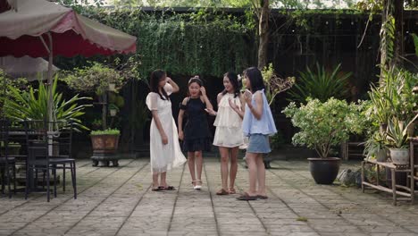 four teenage girls walking and talking outdoors