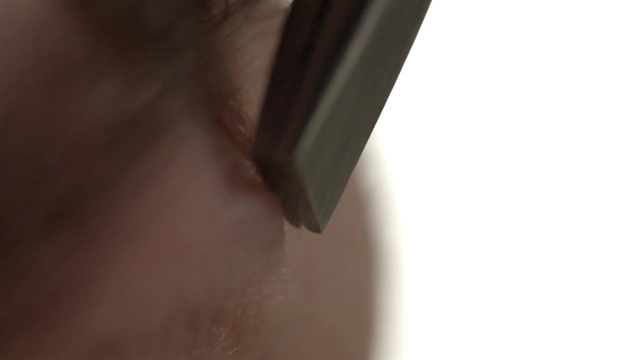 Close up of tweezers removing unwanted hair from an eyebrow