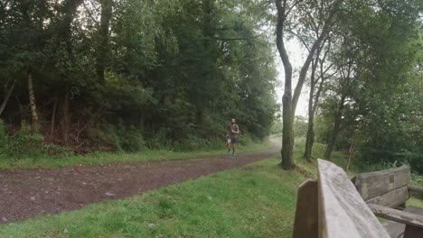 trail runner with backpack exercising in slow motion