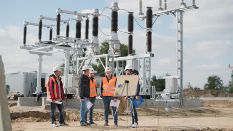 engineers supervise the construction of a transformer substation