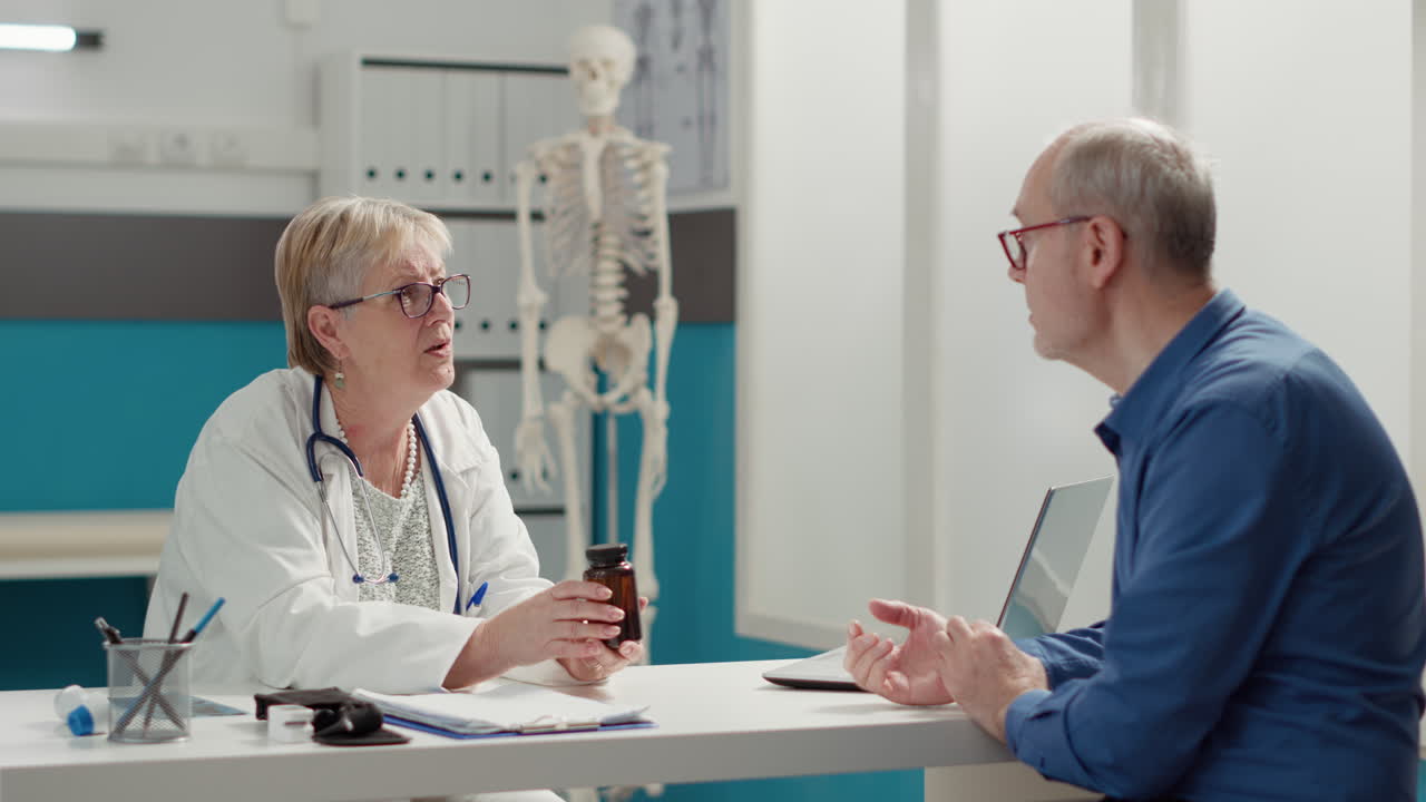 Medical specialist explaining bottle of medication and pills