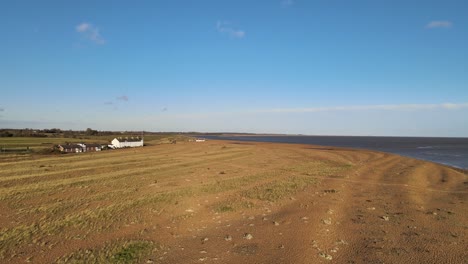 Nature-reserve-Aerial-drone-view-shingle-street-Suffolk-bright-sunny-day