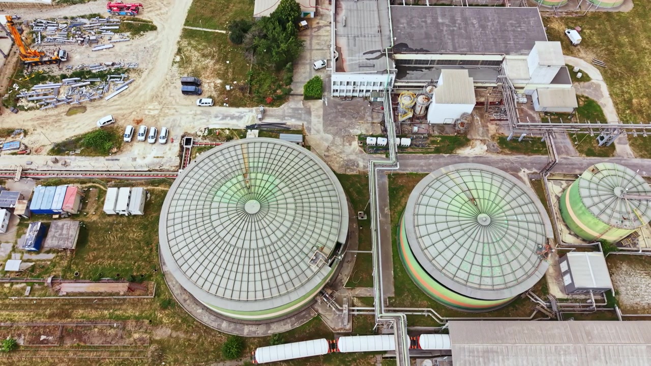 Industrial facility located in a rural area showing large storage tanks and processing buildings surrounded by open land