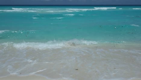 waves of turquoise sea in cancun, mexico