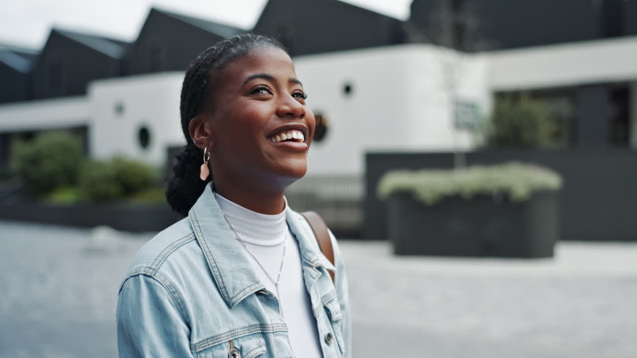 Happy young woman walking down a street