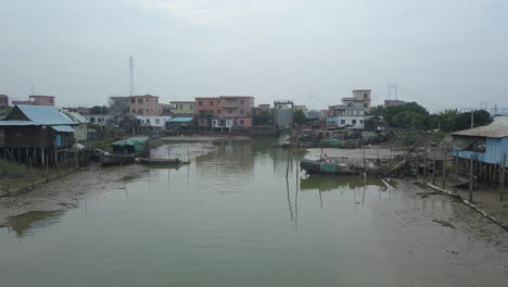 Aerial-shot-of-a-polluted-river-near-the-village-in-Asia