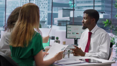 job seeker presents his cv resume to hr recruiters during a corporate interview