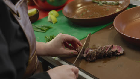 caucasian woman cutting meat