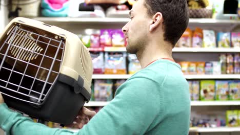 man choose box for transportation his cat in the pet shop