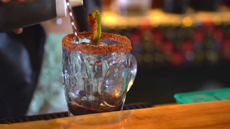 preparing michelada mix. bartender preparing drink