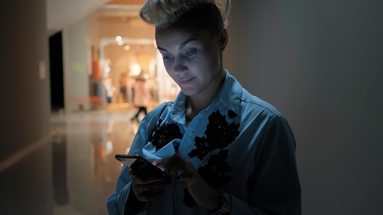 Woman using smartphone in a museum