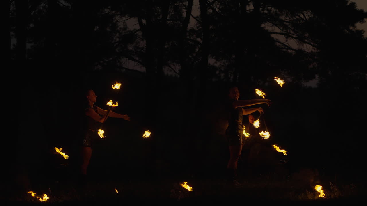 Fire Jugglers in the Forest at Night