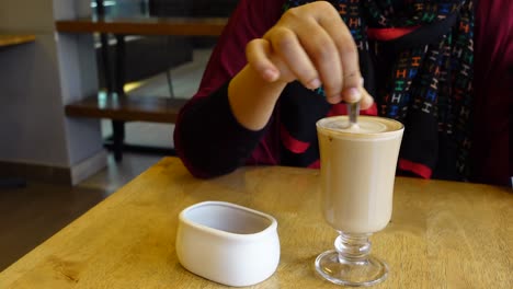 woman enjoying a latte in a cafe