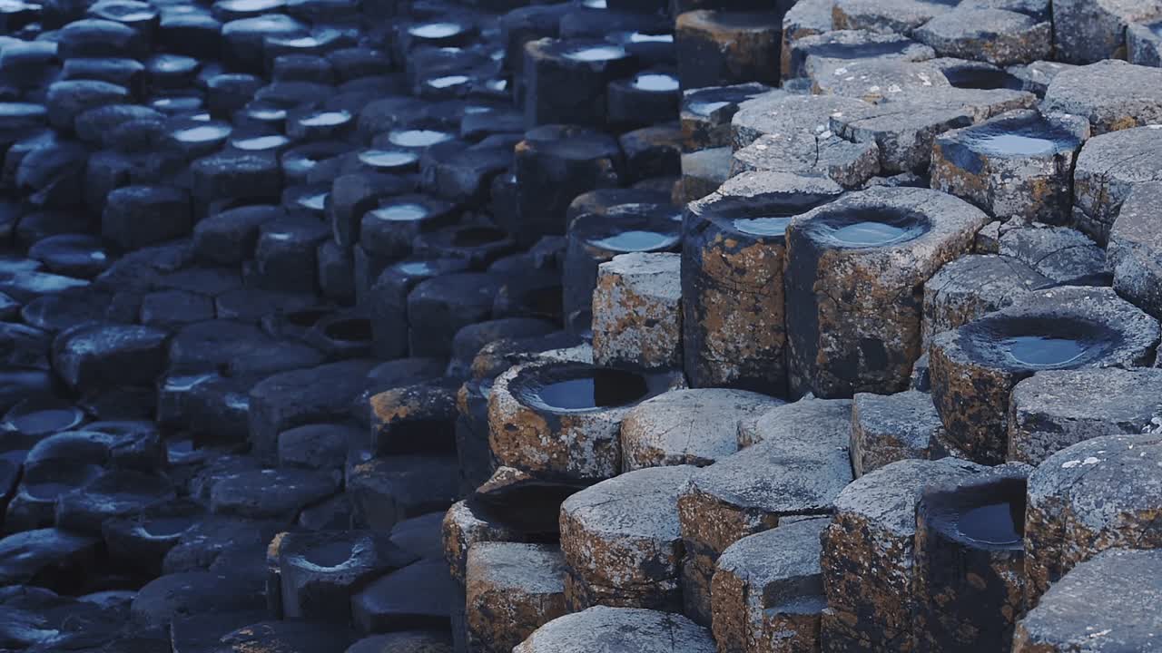 Hexagonal Rock Columns Firmly Fit Together Called Giant's Causeway Is Drenched Of Water In Antrim Coast. -close up shot