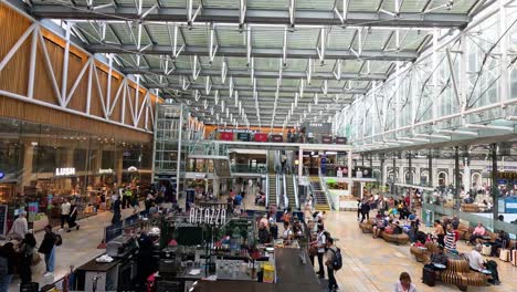 crowds and activity at paddington station, london