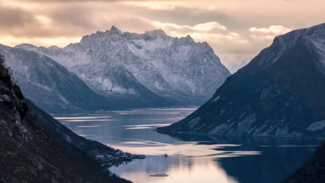 4k time-lapse with norwegian mountains in the background in a lush arctic winter landscape during sunset