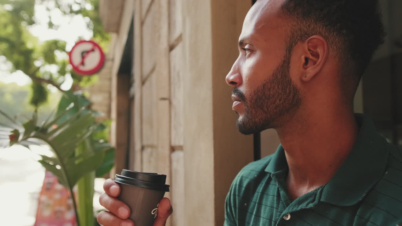 Man with coffee on city street
