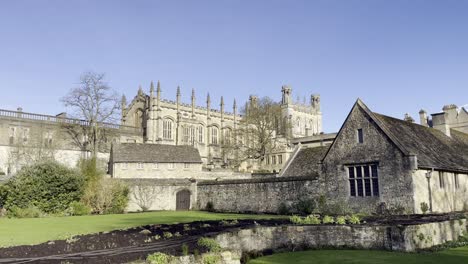 historic view of christ church in oxford with stone buildings, medieval architecture, and a well-kept garden in the foreground