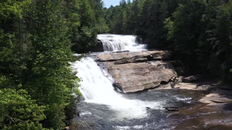 beautiful triple falls waterfall in north carolina forest - aerial