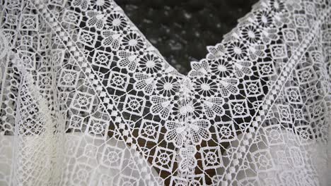 close up wedding dress details of collar hanging on beautiful wooden door