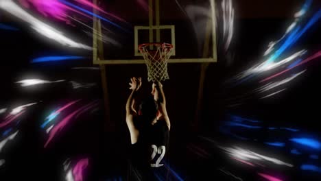 Animation-of-colourful-swirls-over-male-basketball-player-shooting-for-a-hoop