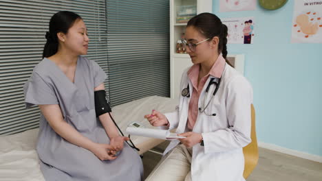 doctor checking patient's blood pressure