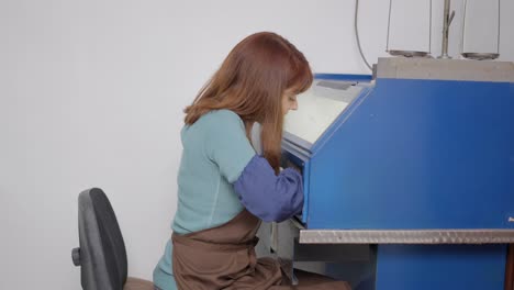 woman working on a machine in a factory