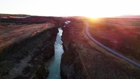 golden sunset over gullfoss river valley in iceland, cinematic aerial forward