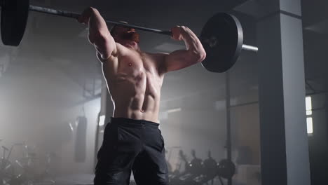 slow motion: man doing deadlift exercise at gym