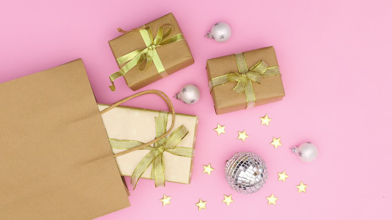 Gifts for Christmas moving in shopping bag on pastel pink theme. Stop motion
