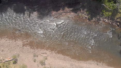 Aerial-shot-moving-along-a-fast-flowing-high-country-river-in-the-Australian-bush