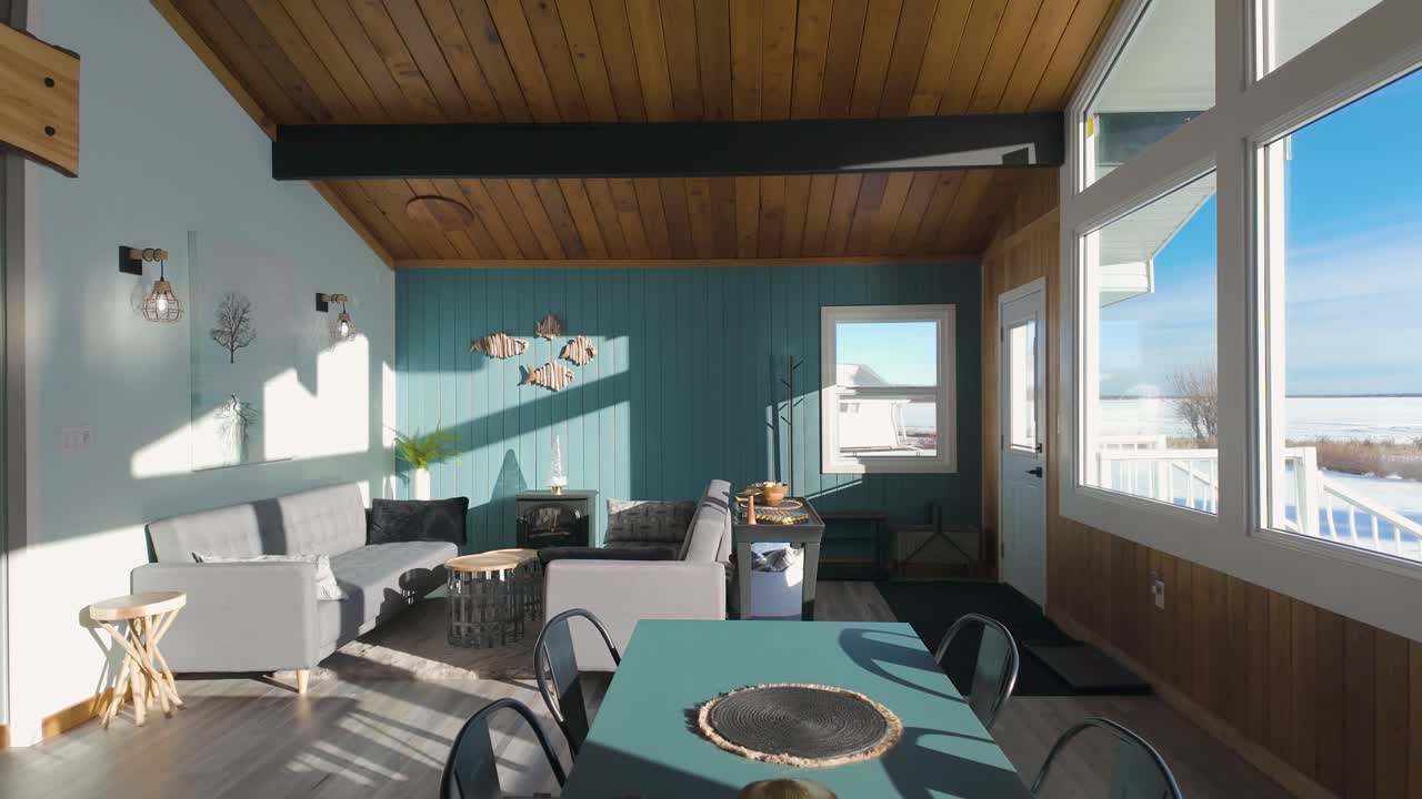 Escape to a vibrant vacation home on the lake in Alberta, featuring a modern and colorful interior with breathtaking waterfront views