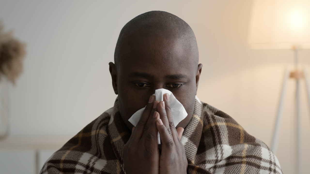 Man with a tissue in his nose