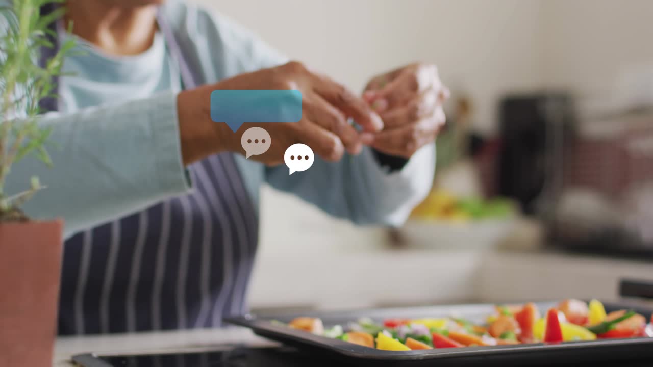 Senior home cook pinching rosemary, generating chat bubbles then sprinkling herbs onto vegetables