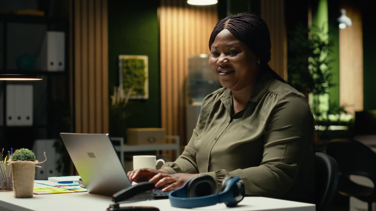 Portrait of black worker engaged in drafting updates and creating summary