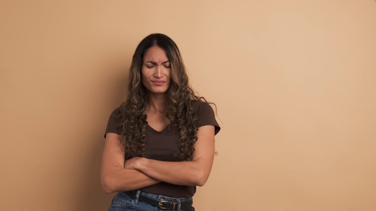 An hispanic woman upset standing crossing arms