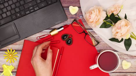 female business table with femininity accessories in red color appear on office table - stop motion