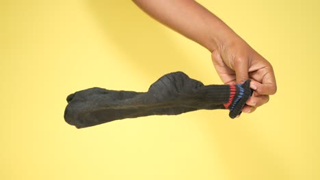 black sock on yellow background