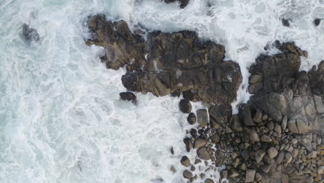 4K-overhead-tracking-shot-of-heavy-surf-on-California-coast