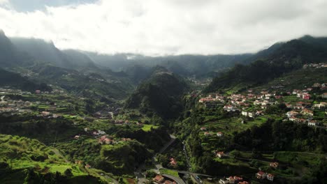 Imágenes-Aéreas-Del-Paisaje-De-Madeira-Con-Montañas,-Cañones,-Pueblo-En-Un-Día-Nublado