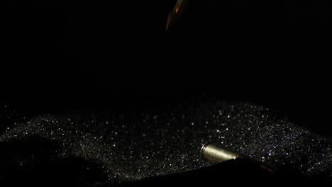 300 aac blackout bullets falling over smokeless gunpowder in black backdrop