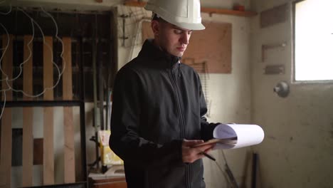 home renovation - young structural inspector reviewing details for house renovation