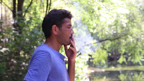 man smoking in forest