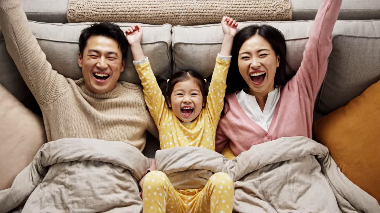 Happy Asian family celebrating on the couch