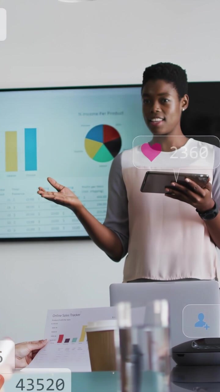 Woman tapping tablet in sales sync causing social metric overlays over her chart showing ROI
