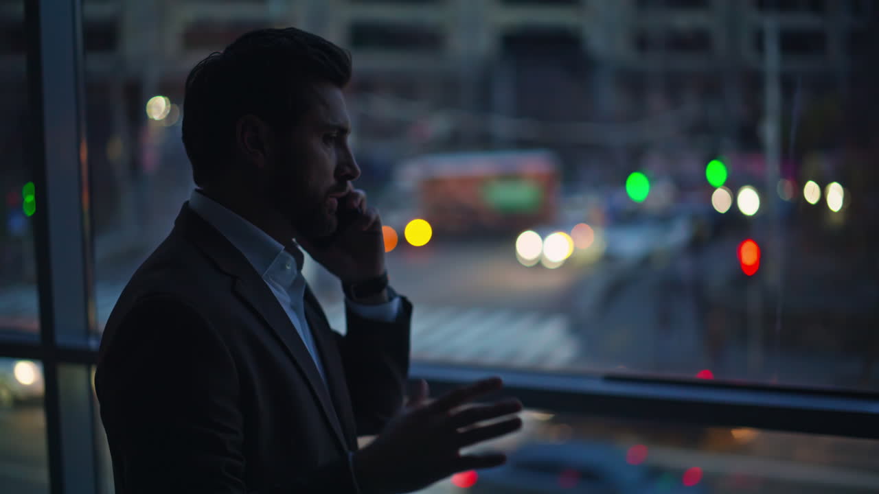 Calling entrepreneur standing dark corridor looking evening city view closeup