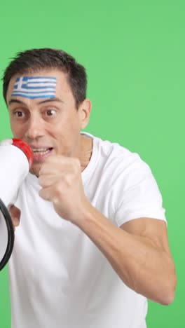 Excited man with greek flag on face using a megaphone