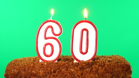 cake with the number 60 lighted candle. chroma key. green screen. isolated