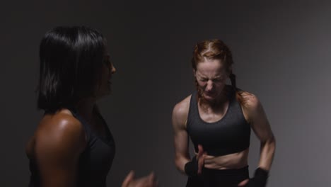 two women exercising at the gym