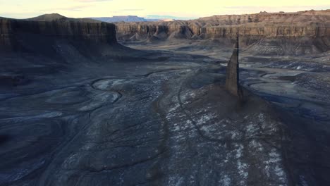 sharp rock formations in mountainous valley under sunset sky